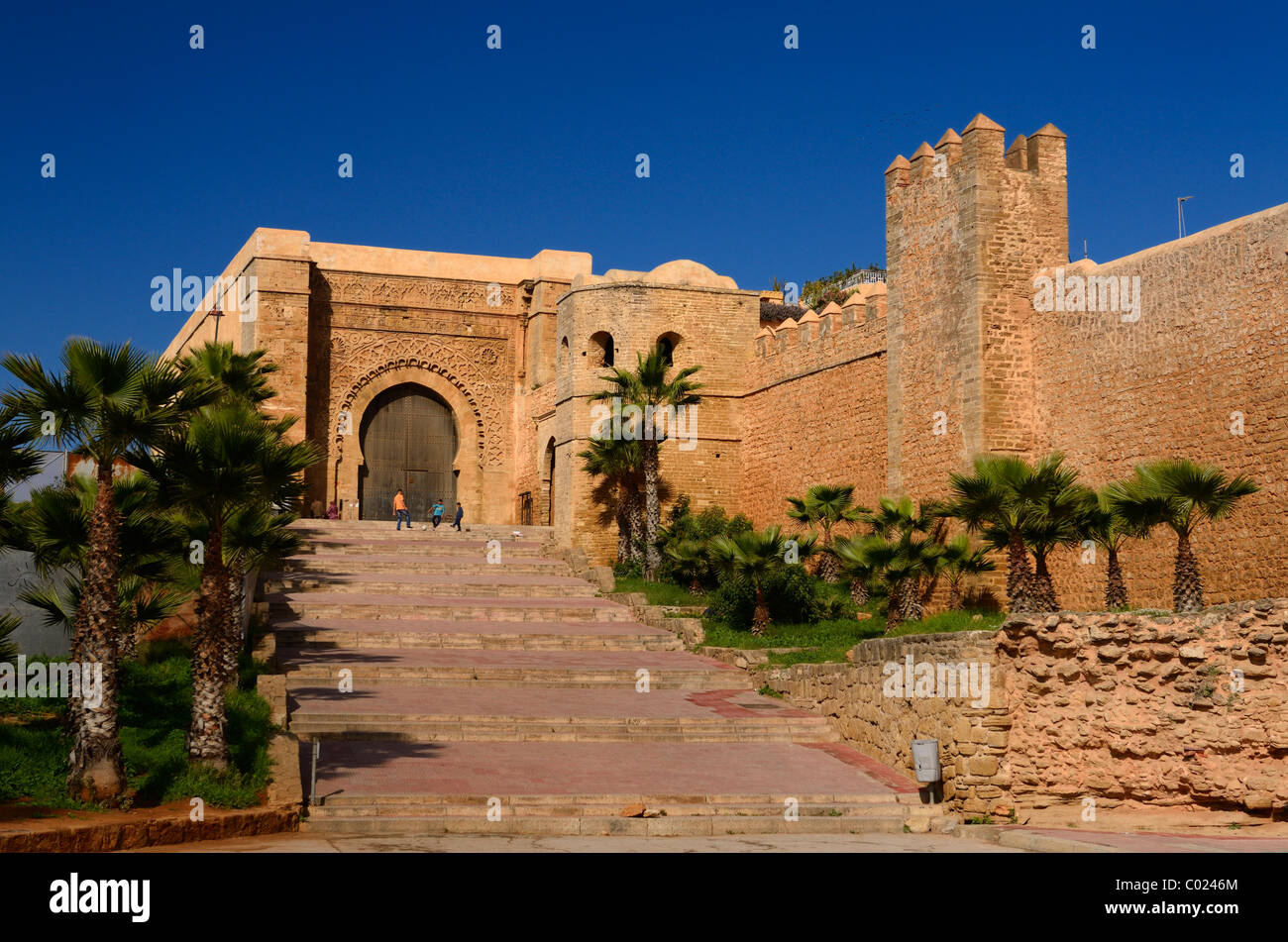 Boys playing soccer at Bab Oudaia gate to the Kasbah El Alou cemetery in Rabat Morocco North Africa Stock Photo
