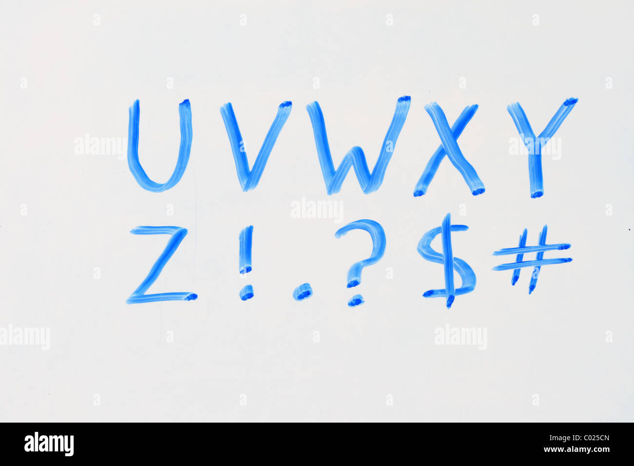 the letters U V W X Y Z and punctuation in blue marker on a dry erase white board Stock Photo