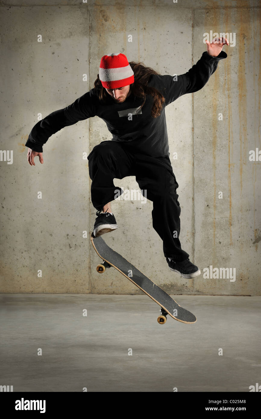 Skateboarder jumping over grunge background Stock Photo