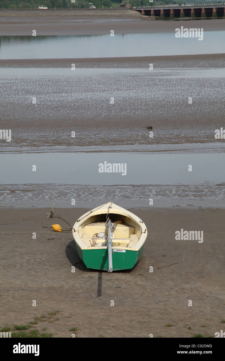 Beached sailing dingy at low tide in estuary Stock Photo