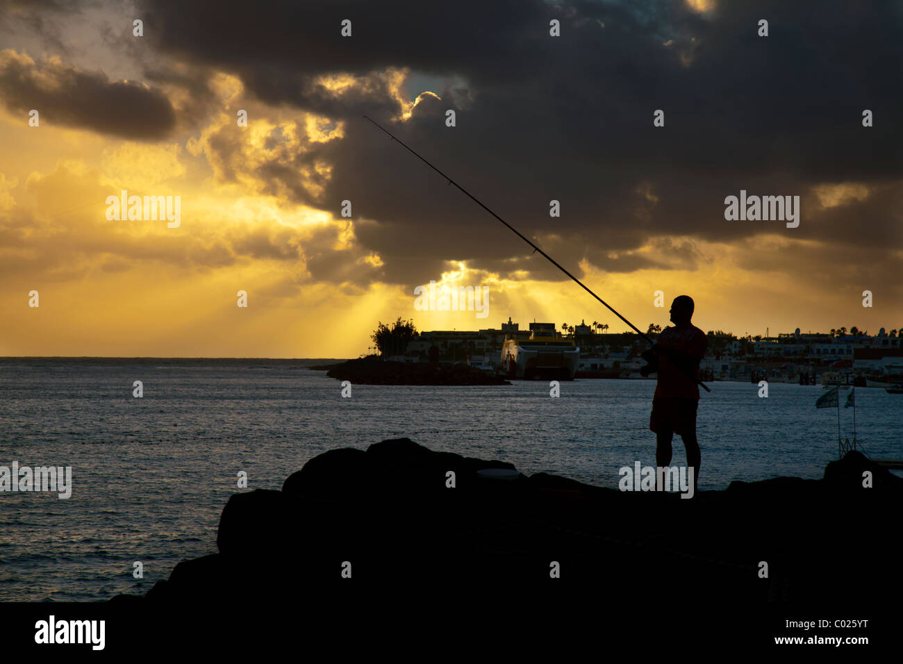Fishing at sunset Stock Photo - Alamy