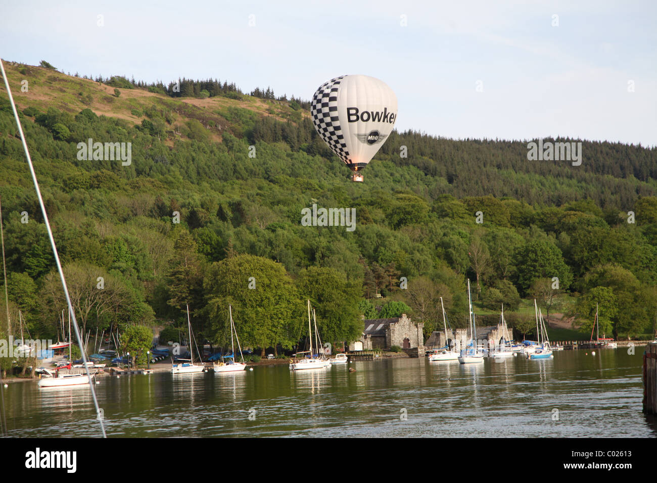 Hot air balloon floating above a lake in the Lake District Stock Photo