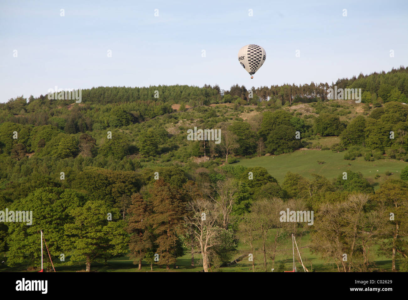 Hot air balloon rising over the hills in the Lake District Stock Photo