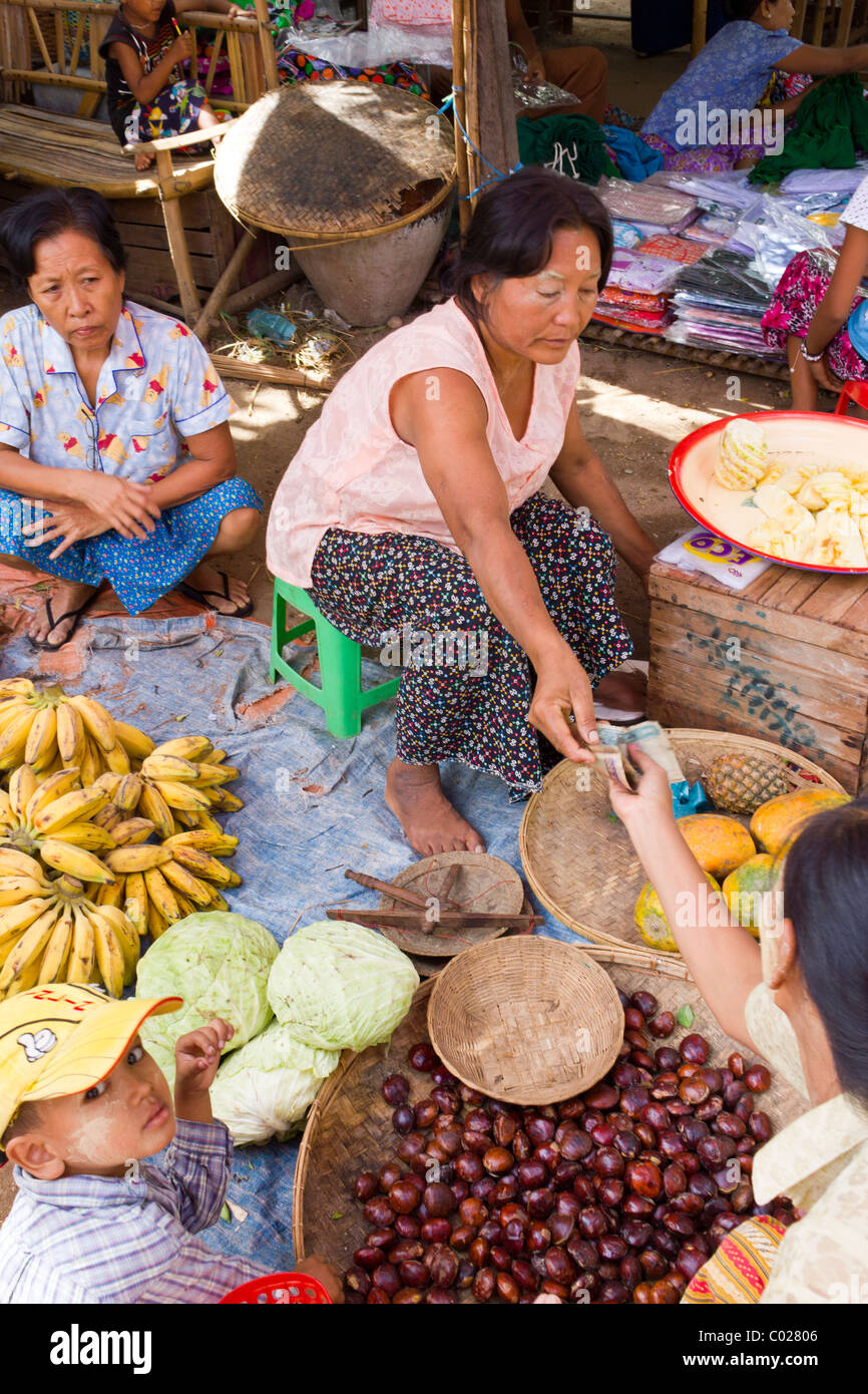 woman buying food from seller, daily market, New Bagan, Burma Myanmar Stock Photo