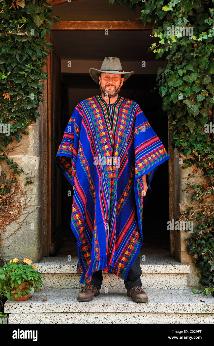 Man in long Bolivian poncho and hat in front of a door, Tauchersreuth,  Middle Franconia, Bavaria, Germany, Europe Stock Photo - Alamy