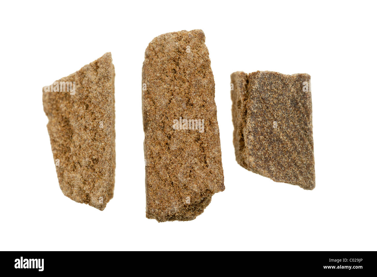 pieces of hashish, photo taken with a macro lens, isolated on a white background Stock Photo