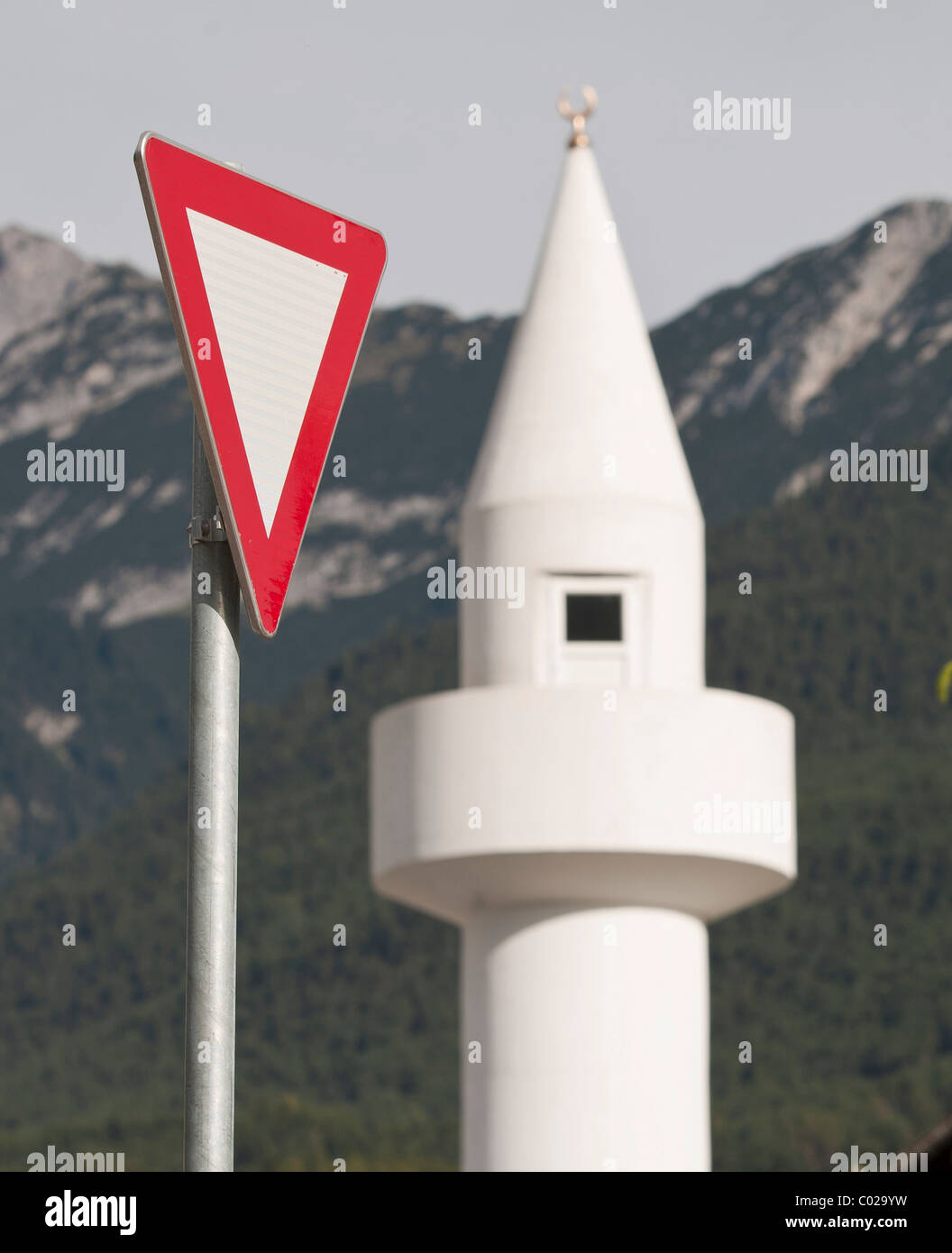 Yield-sign with minaret, controversial mosque in Telfs, Tyrol, Austria, Europe Stock Photo