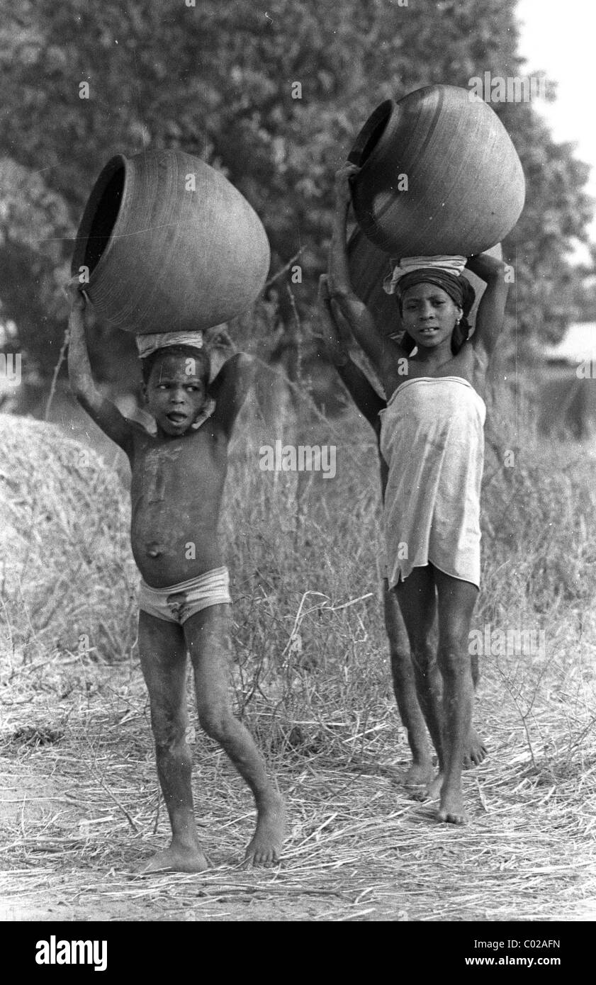Children carrying pots Stock Photo - Alamy