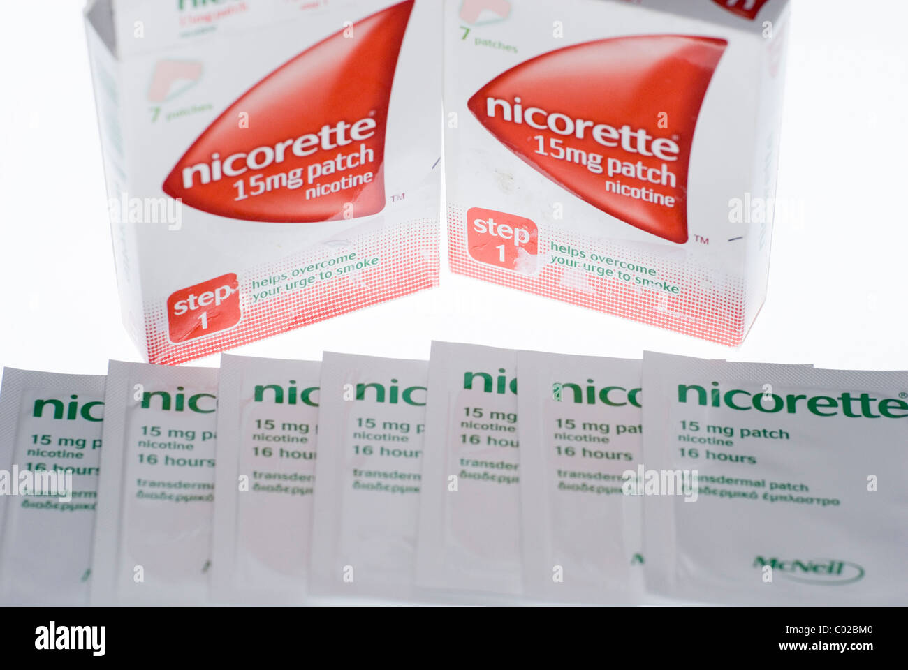 Two Boxes of Nicorette Nicotine Patches, with Patches Spread Before