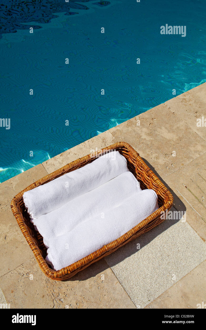 white towels in basket by swimming pool Stock Photo Alamy
