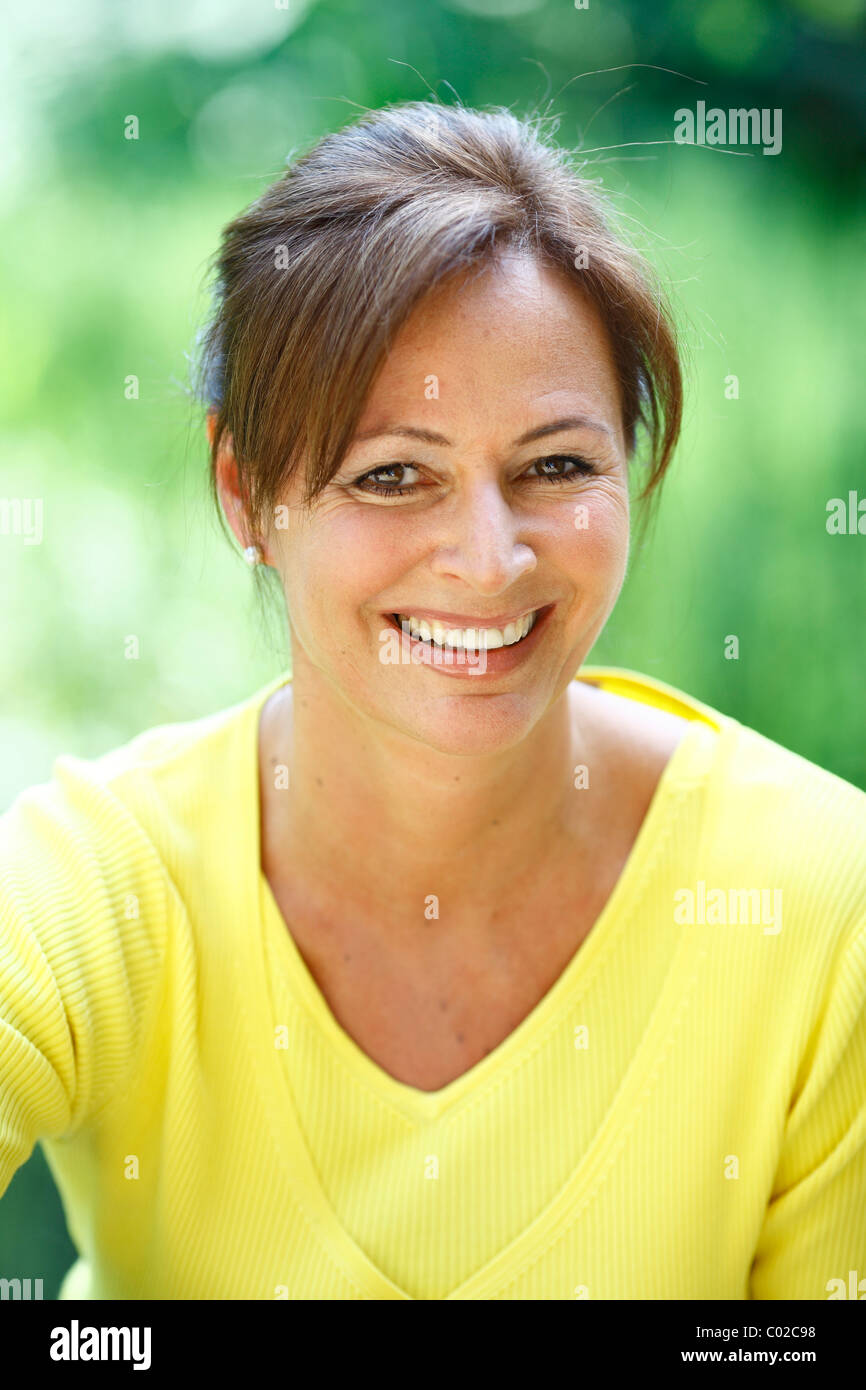 Woman, 45 years, wearing casual clothes in natural surroundings Stock Photo