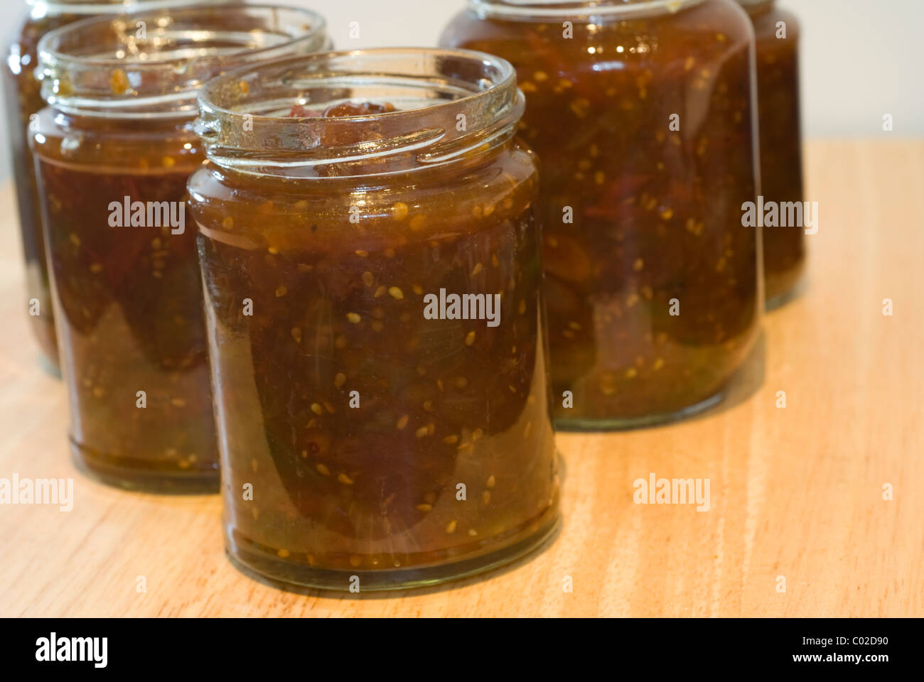 Potting freshly made green tomato chutney into jars Stock Photo Alamy