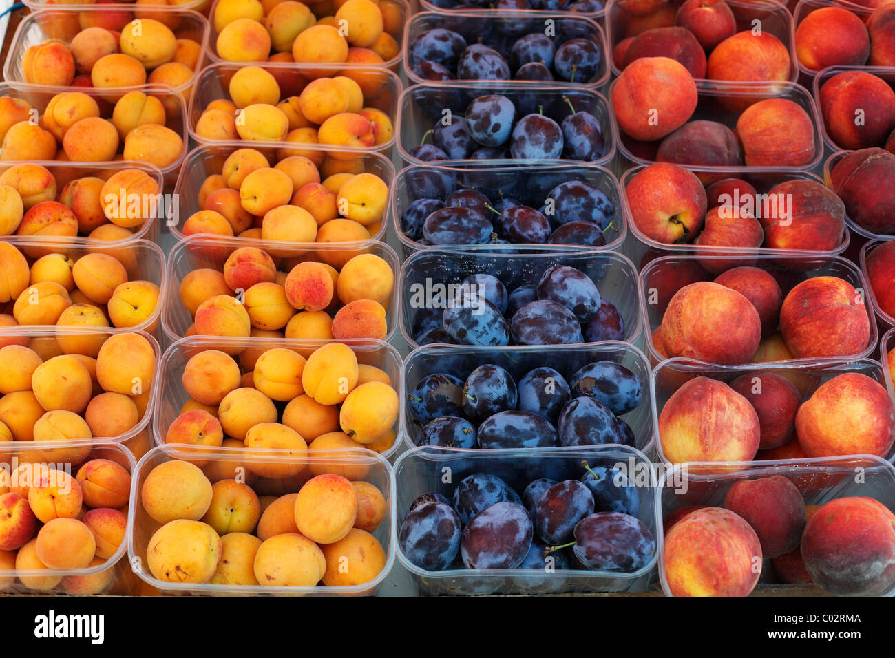 Apricot, plums and peaches in plastic cups, Wachau, Lower Austria, Austria, Europe Stock Photo