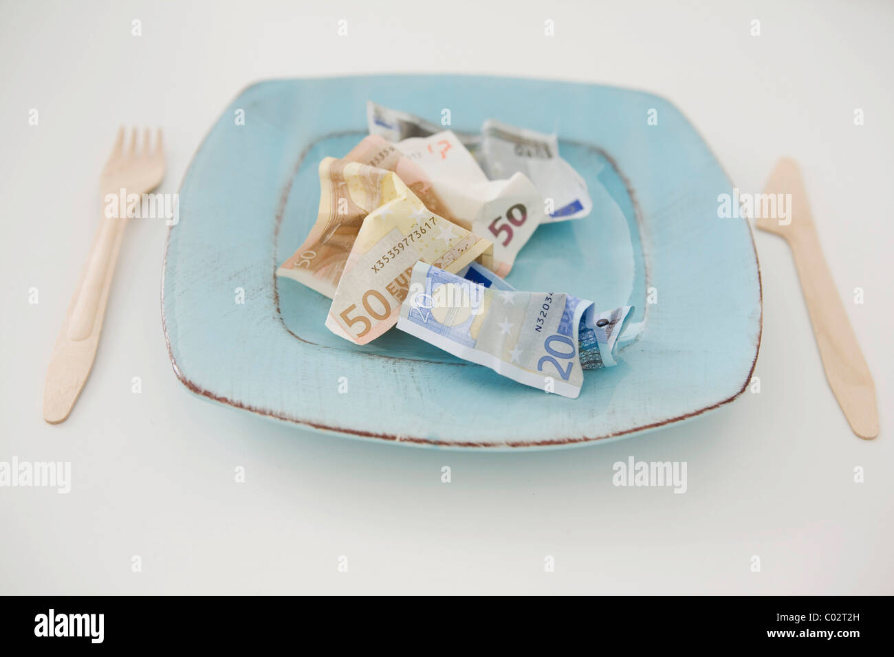 Banknotes on a plate, food costs Stock Photo