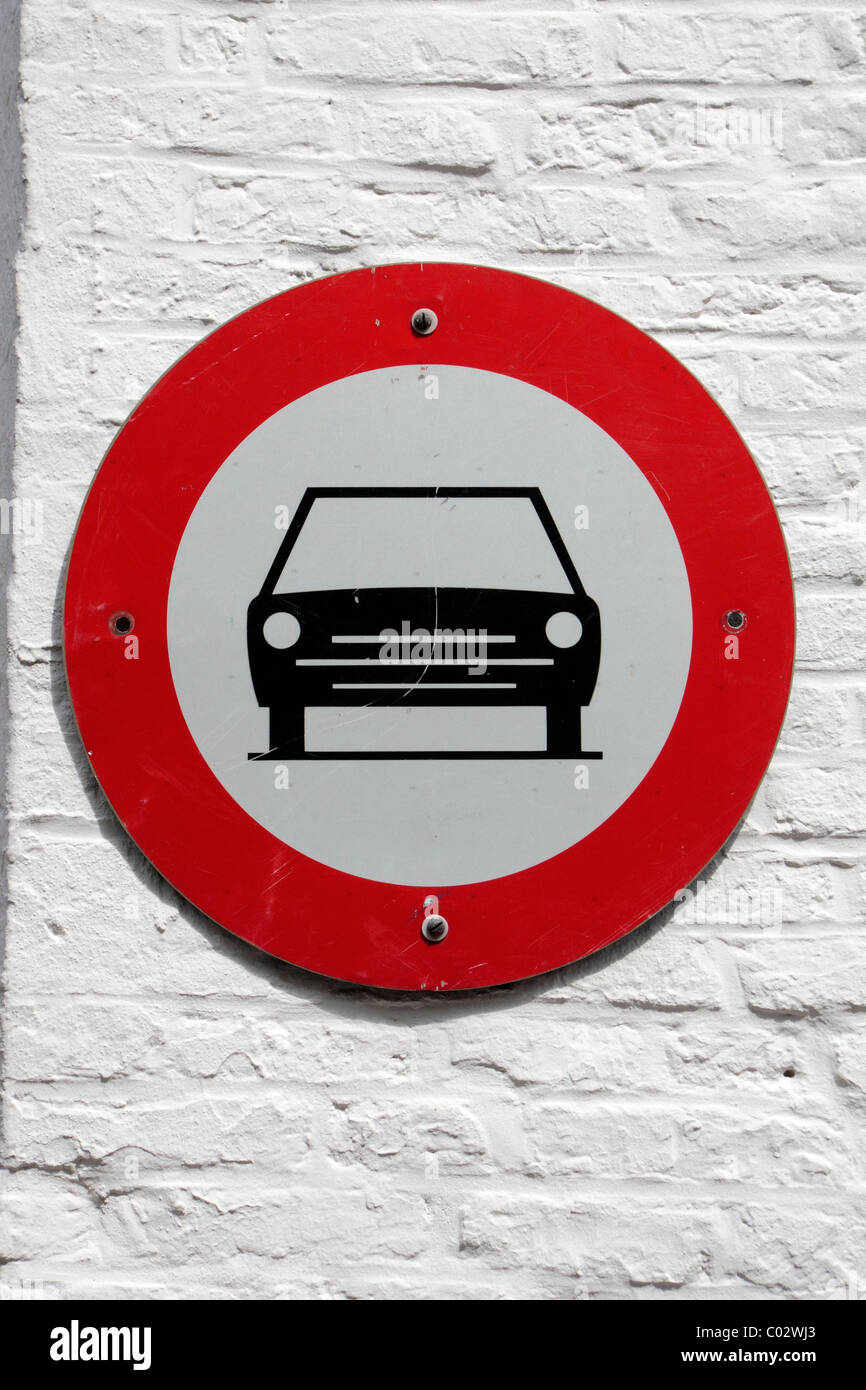 Belgian traffic sign for no cars allowed (black car on white background inside red circle) in Bruges (Brugge), Belgium. Stock Photo