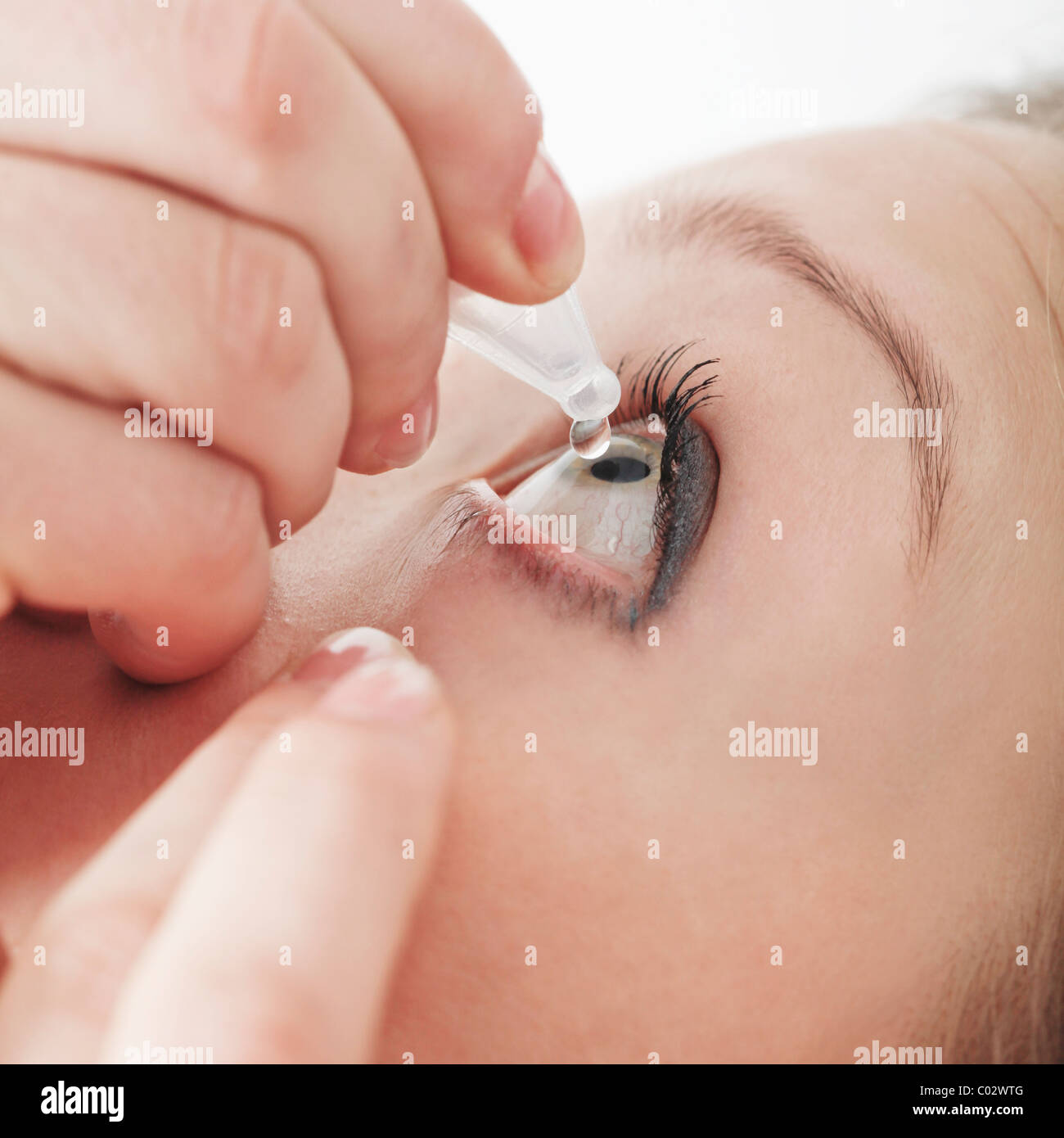 young woman with singledose eye drop Stock Photo Alamy