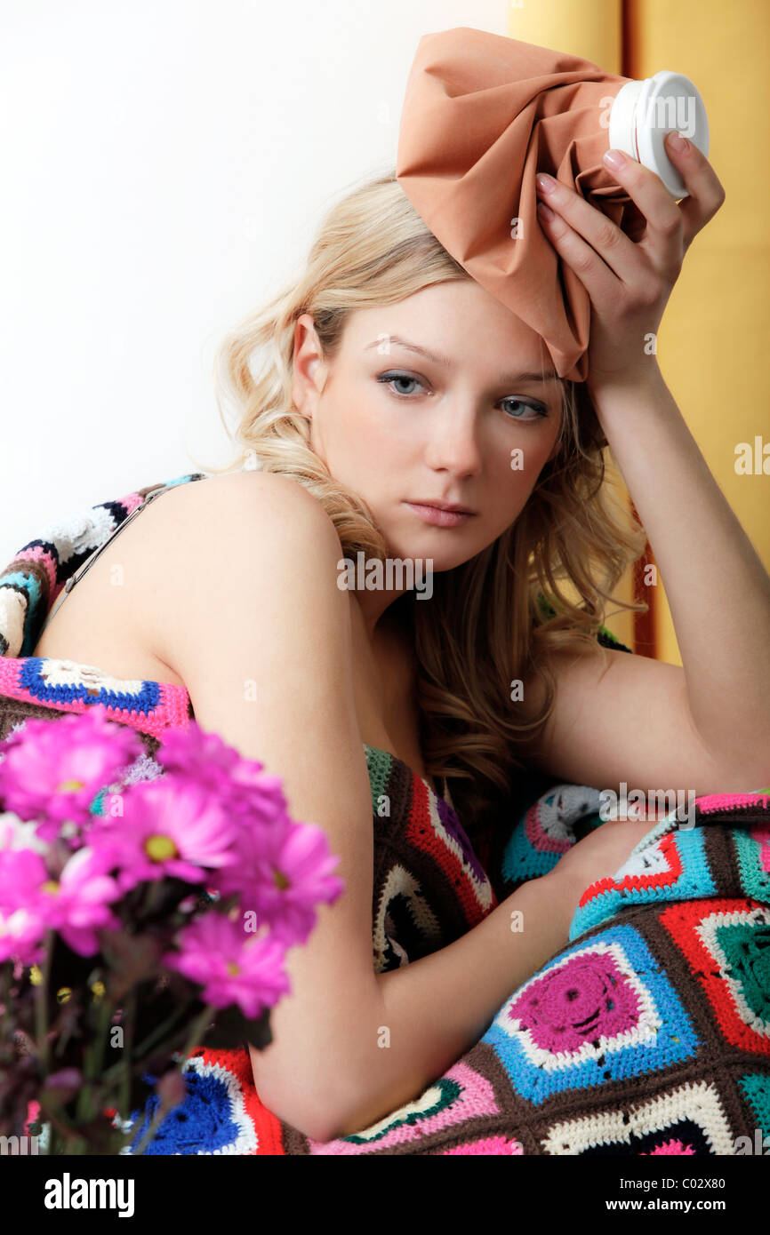 girl under a blanket with a bag of ice on his head Stock Photo Alamy