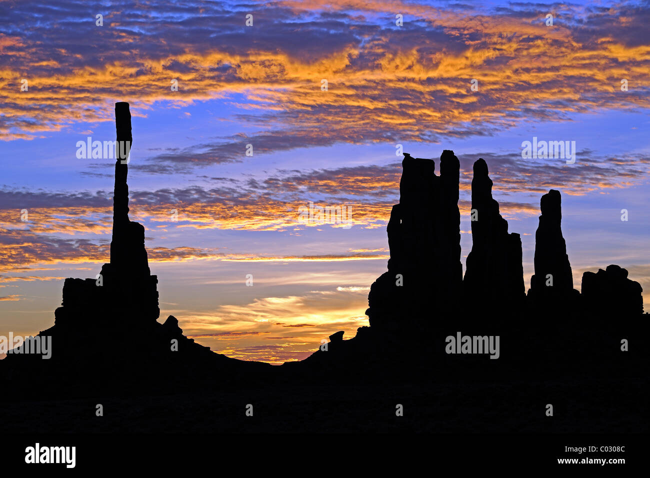Sunrise with Totem Pole rock formation in backlight, Monument Valley