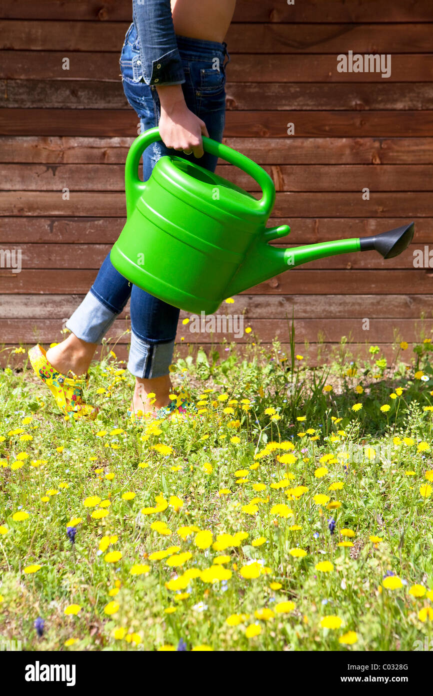 girl with watering can Stock Photo Alamy