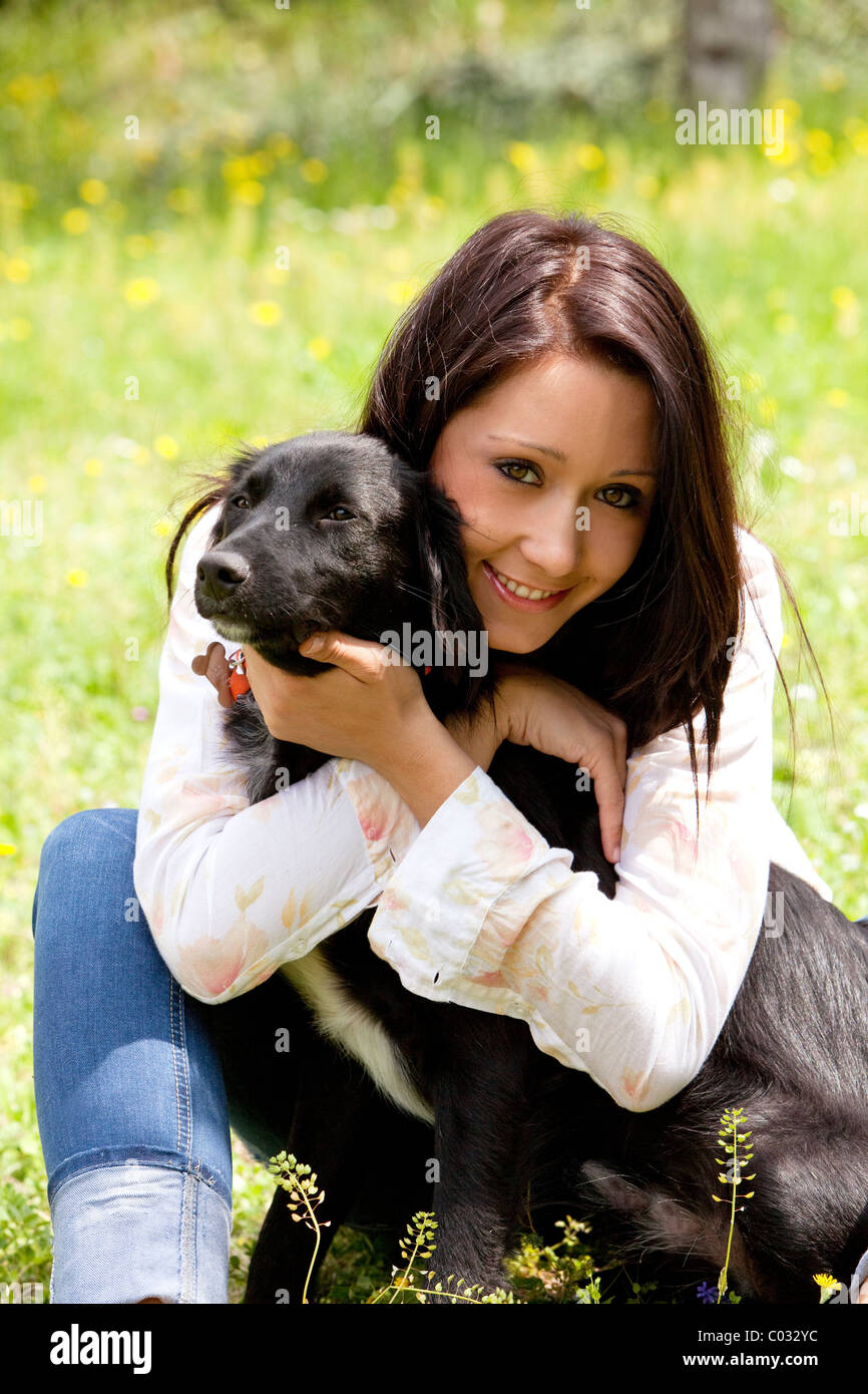 girl embracing her dog, outdoor Stock Photo