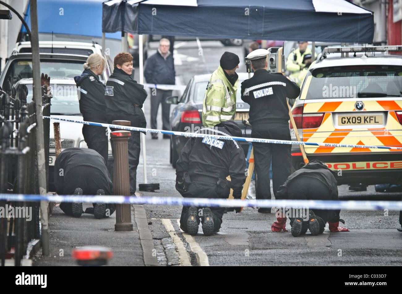 Police investigate the crime scene where police shot dead a suspect Stock Photo