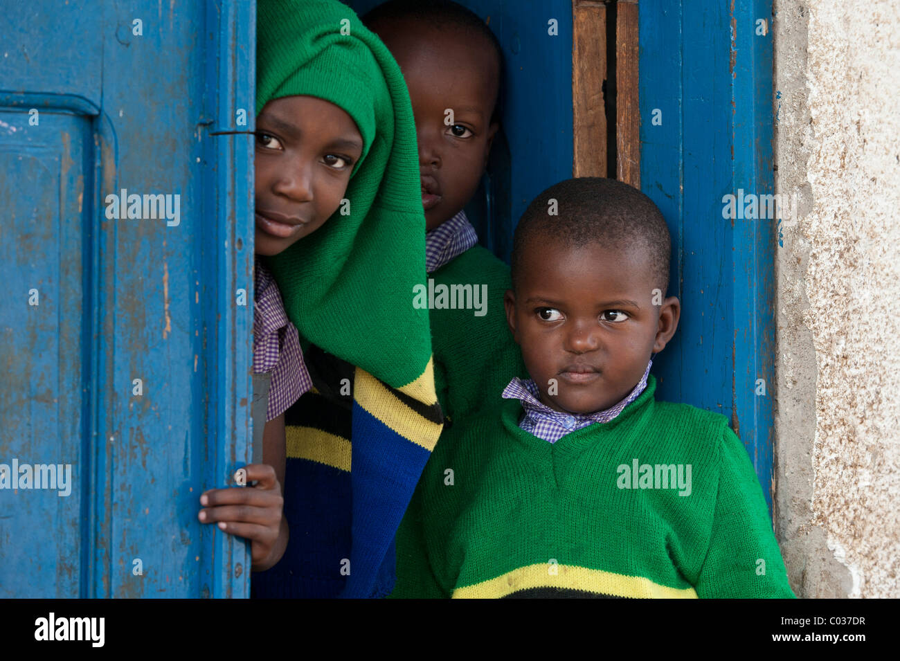 Children, 4-6 years, African children standing at a school door, Tanzania, Africa Stock Photo