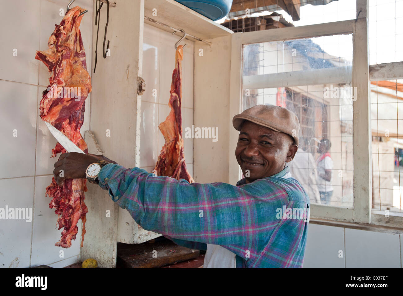 Butcher cutting meat, African man, Tanzania, Africa Stock Photo