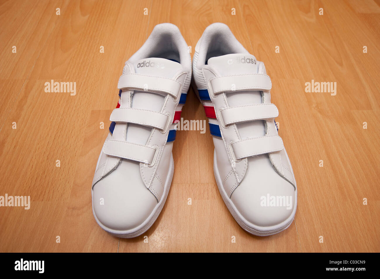 A picture of a brand new pair of adidas velcro fastening for kids training shoes ( trainers ) Stock Photo