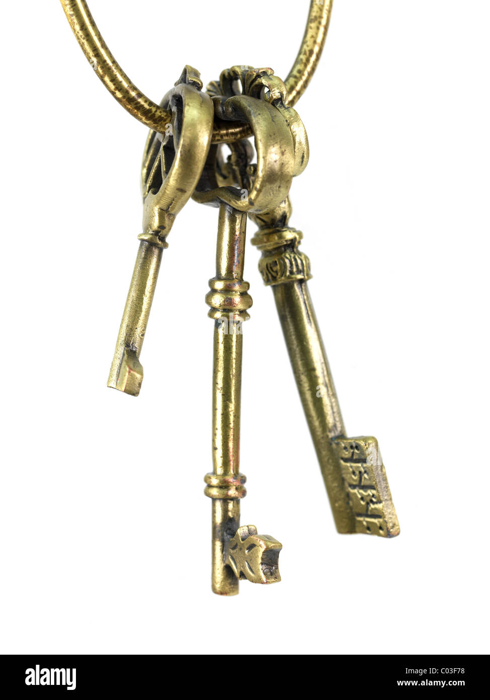 Vintage brass keys isolated against a white background Stock Photo - Alamy