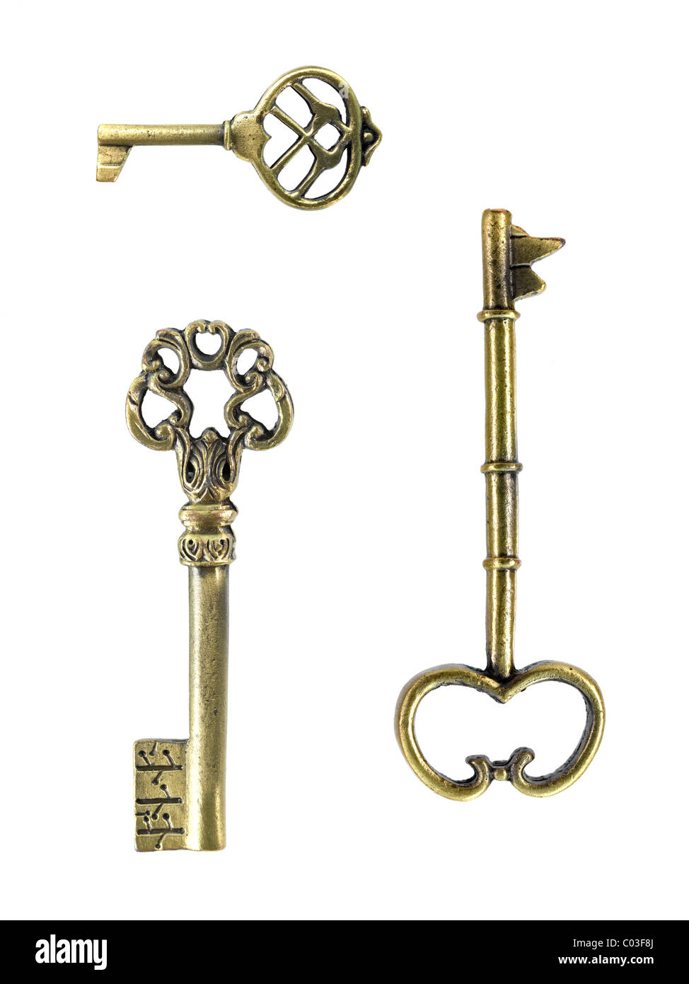 Vintage brass keys isolated against a white background Stock Photo - Alamy