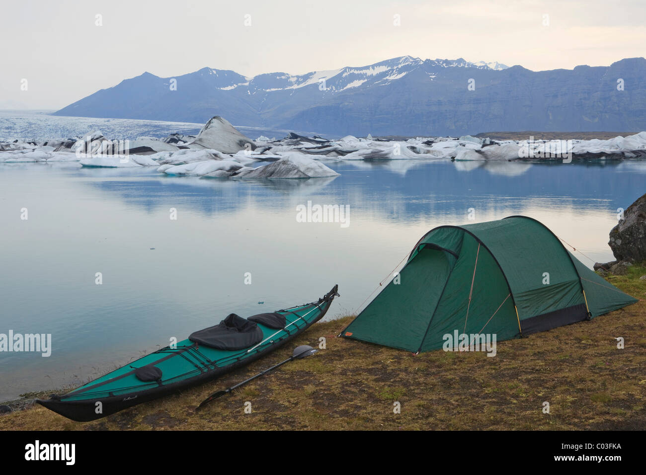 Overnight camp with a tent and a folding kayak beside the Joekulsarlon glacial lake, Iceland, Europe Stock Photo