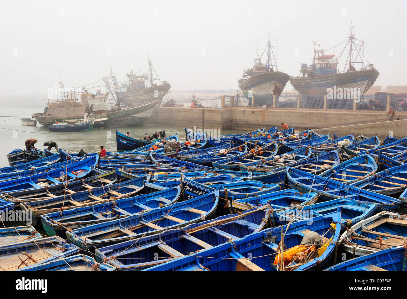 Small blue fishing boats and trawlers in the fishing port of Essaouira, Atlantic coast, Morocco, Africa Stock Photo