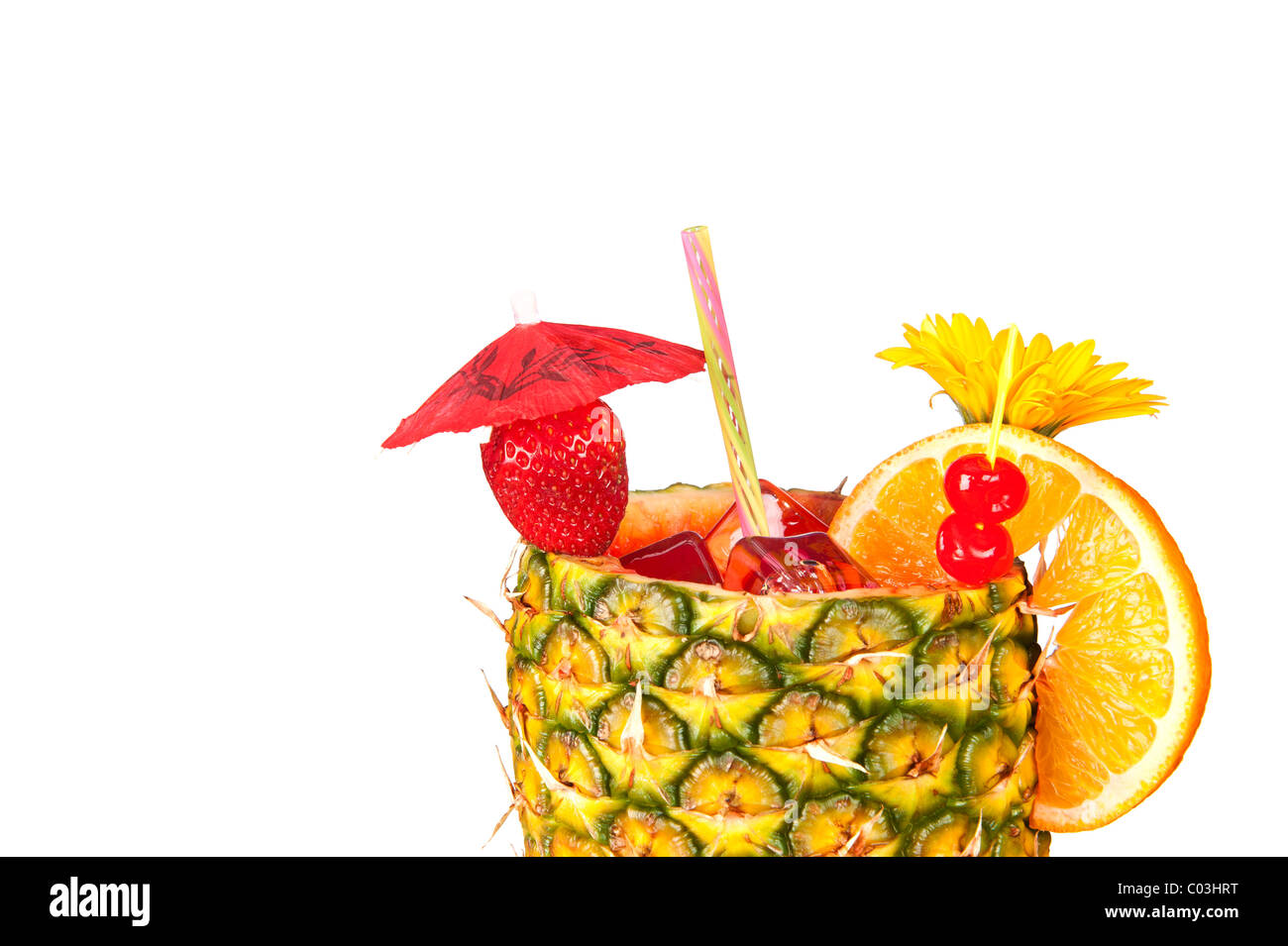 A cold, refreshing tropical rum drink with a pineapple glass Stock Photo