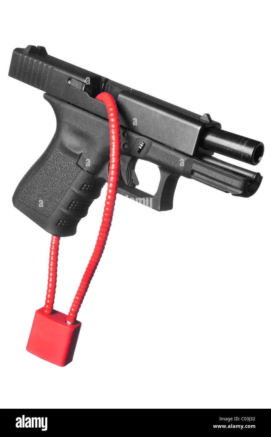A hand gun firearm is locked with a safety cable to prevent anyone from firing the weapon. Stock Photo