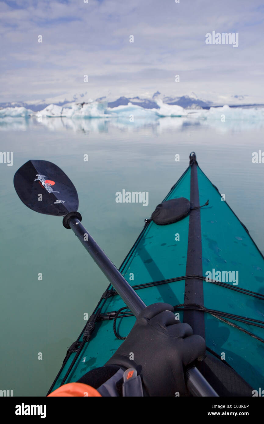 Kayaker paddling among icebergs on the Joekulsarlon glacial lake, Iceland, Europe Stock Photo