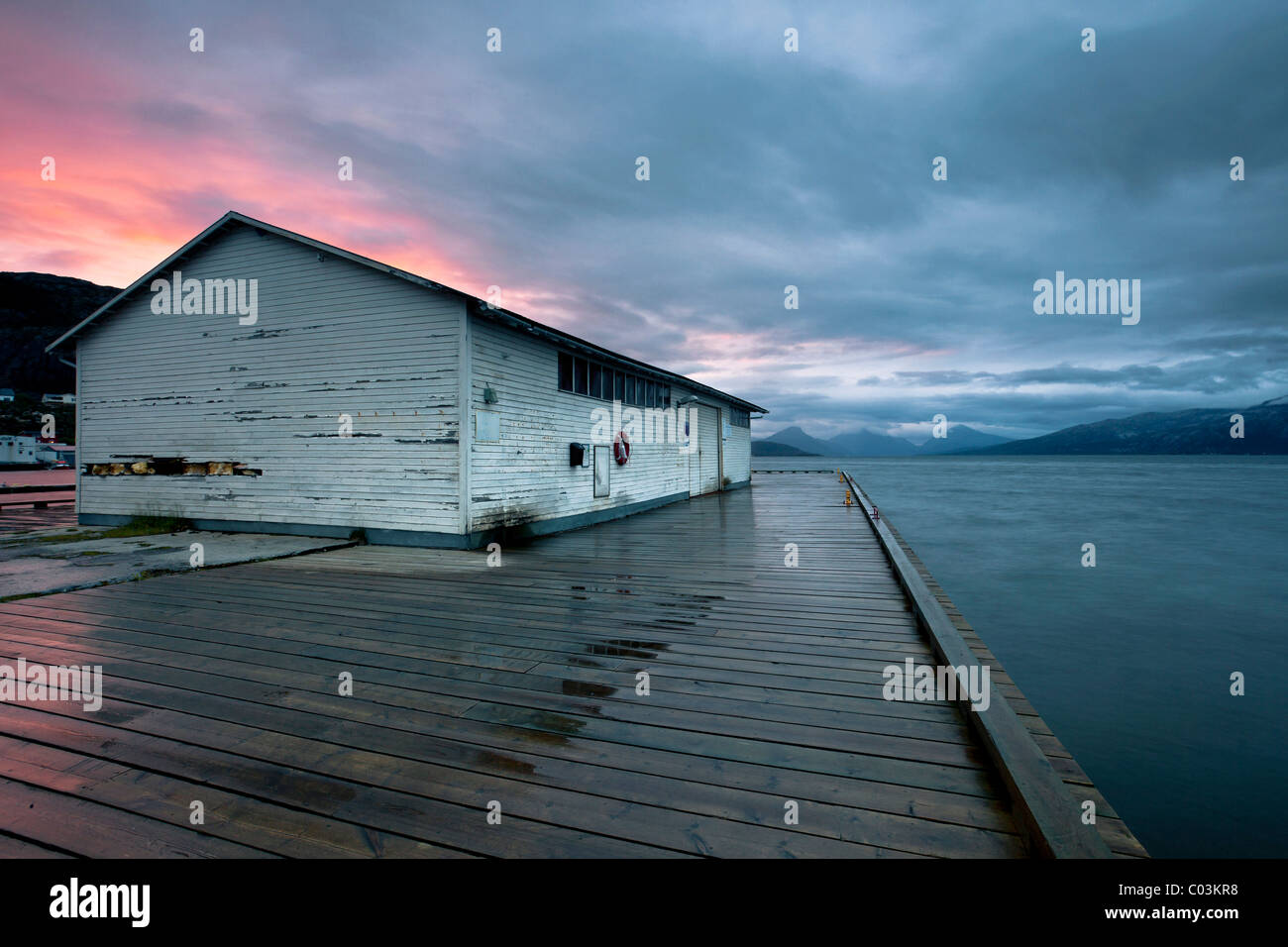 Midnight sun and rain at the port of Lødingen, Hinnøya Island, Lofoten, Norway, Europe Stock Photo