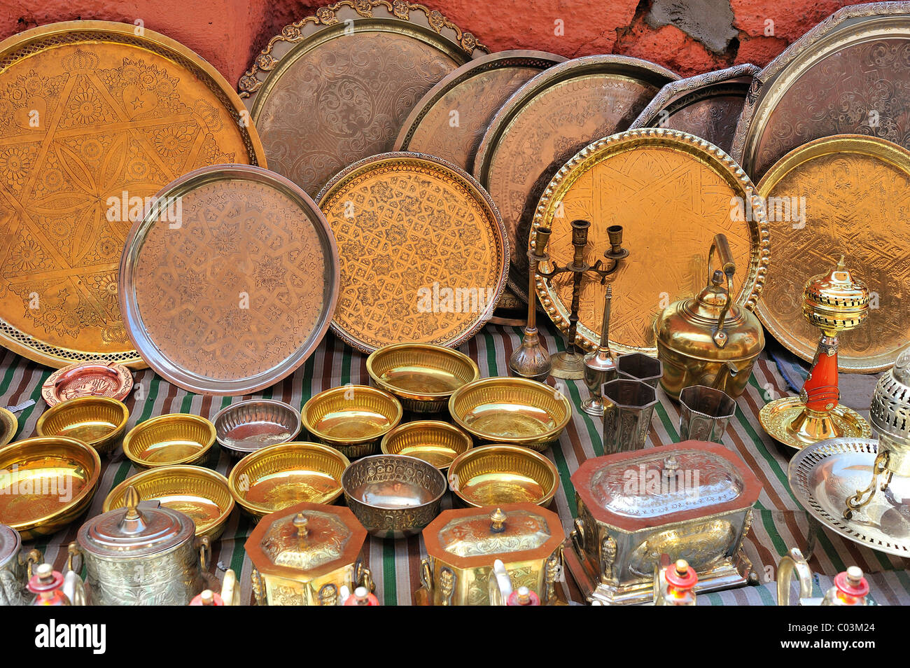 Artfully engraved brass plates and vessels being sold at the souk markets or bazaar, Marrakech, Morocco, Africa Stock Photo