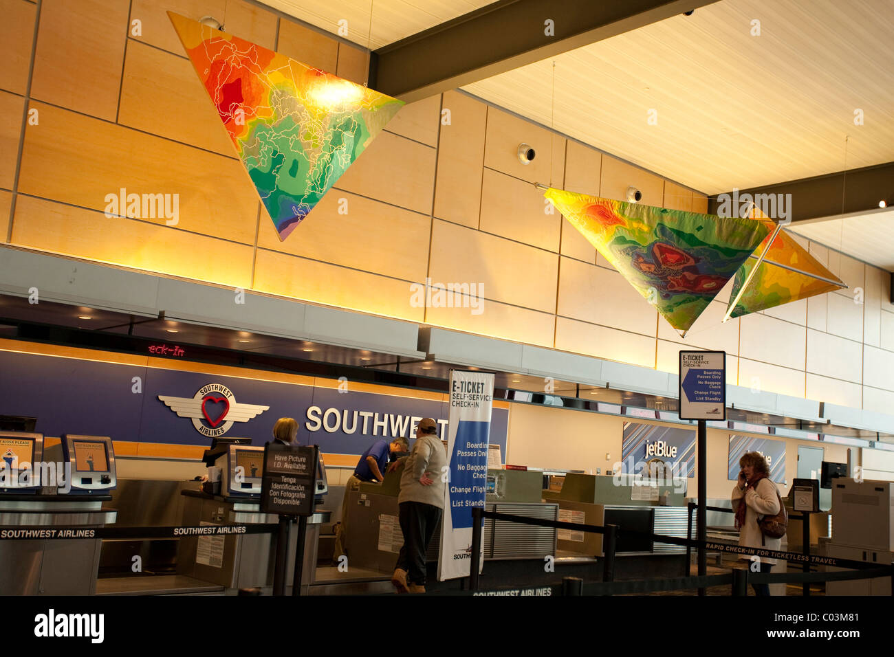 Colorful art hangs over Southwest Airlines in an nearly vacant Bradley International Airport during a snow emergency Stock Photo
