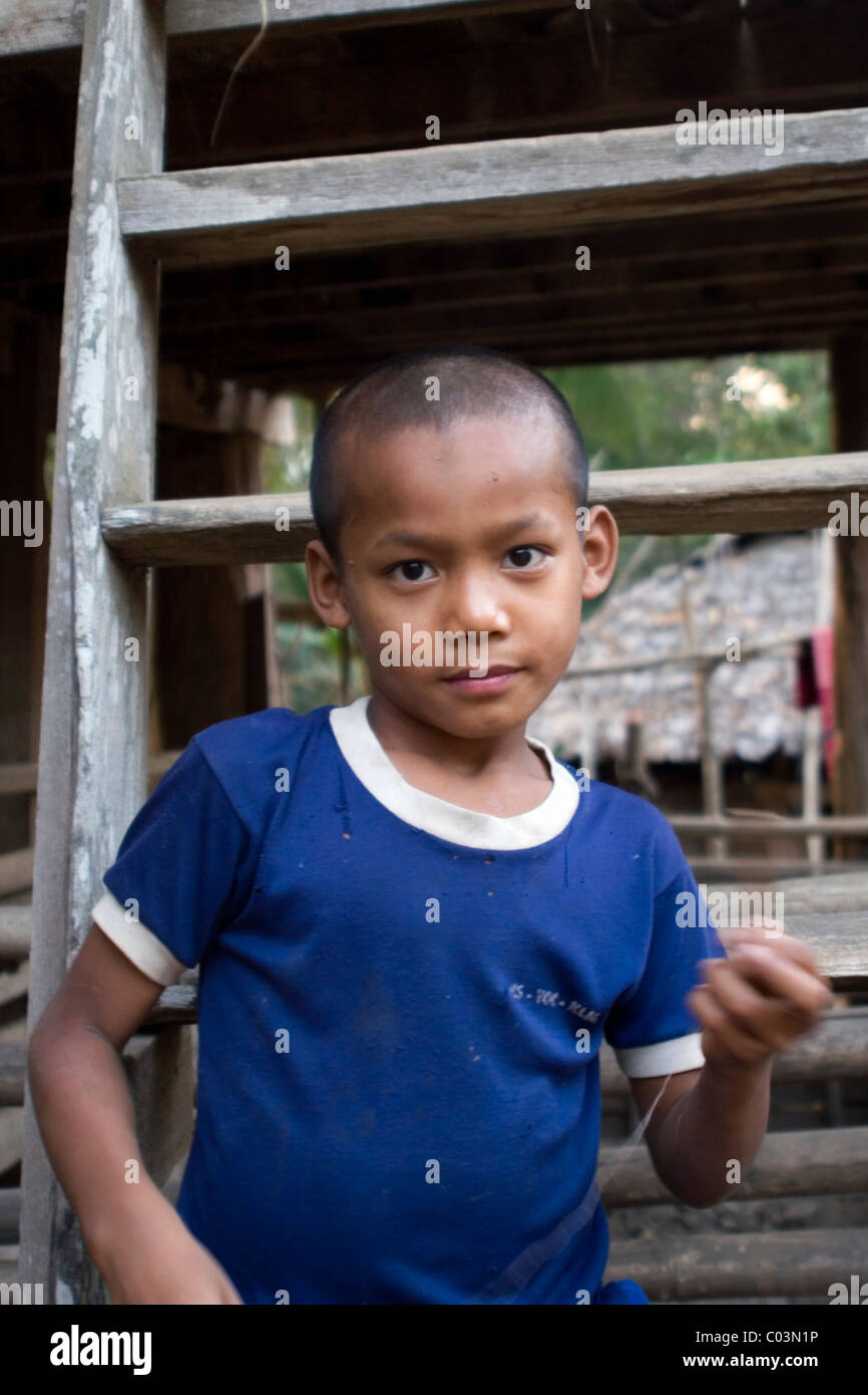 A young Burmese boy whose family fled Burma (Myanmar) is standing ...