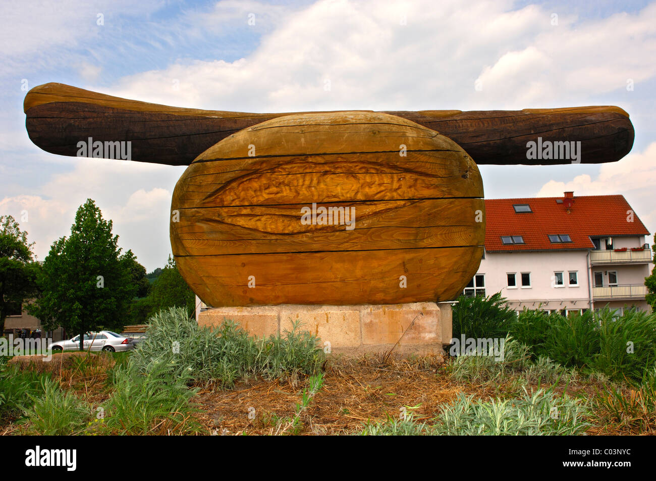 Wooden sculpture of a fried sausage, or Thuringian sausage, Holzhausen, Thuringia, Germany Stock Photo