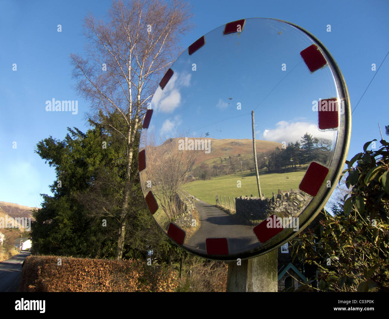 A concave mirror reflects the scene in the village of Threlkeld, Cumbria in the English Lake District. Stock Photo