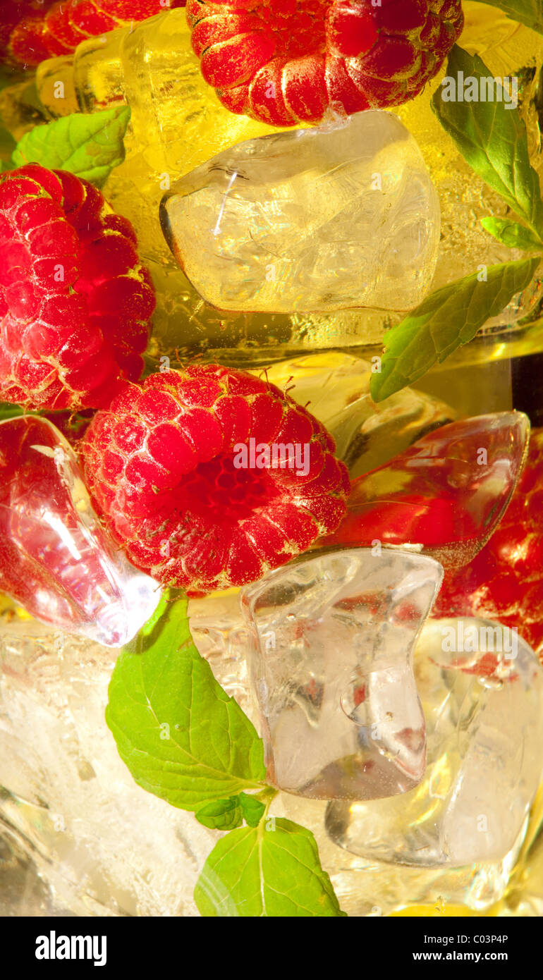 Yellow Raspberry Drinks Closeup of a yellow cocktail drink with raspberries and mint Stock ...