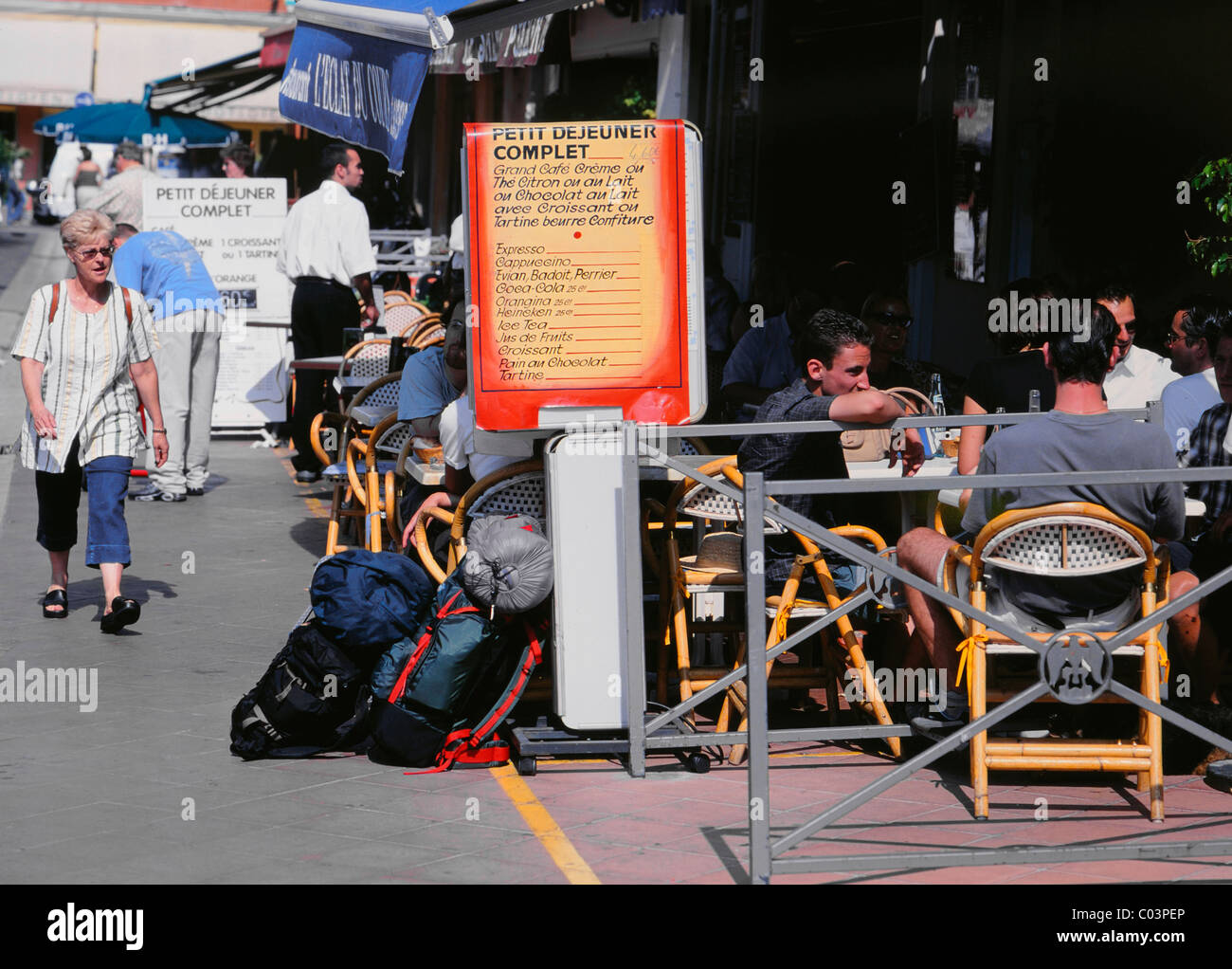Nice, Cote d'Azur, France. Place Charles Felix, backpackers sitting outside café. Breakfast menu Stock Photo