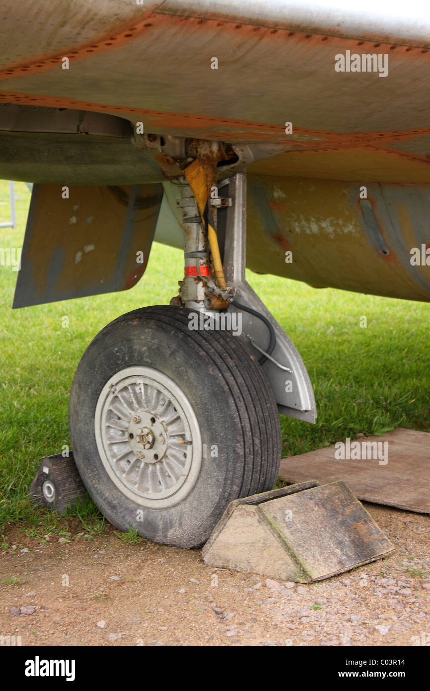 A landing wheel of an airplane with chocks. The plane is stationery