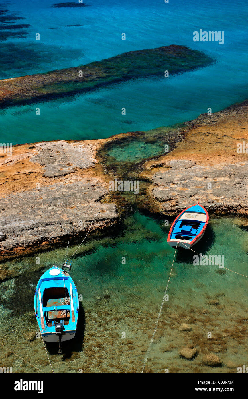 Milos island, Greece. A small natural 'harbor' very close to Fyriplaka beach with fishing boats and crystal clear waters. Stock Photo