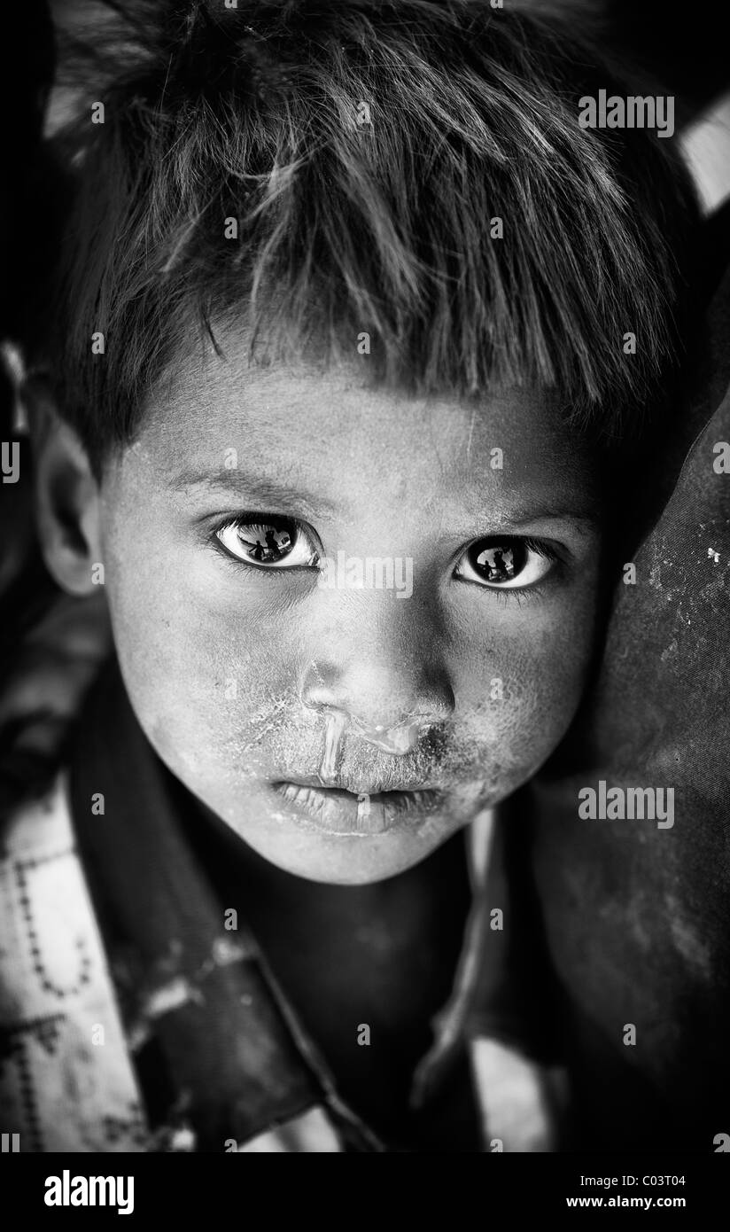 Young poor lower caste Indian street infant boy. Andhra Pradesh, India. Monochrome Stock Photo