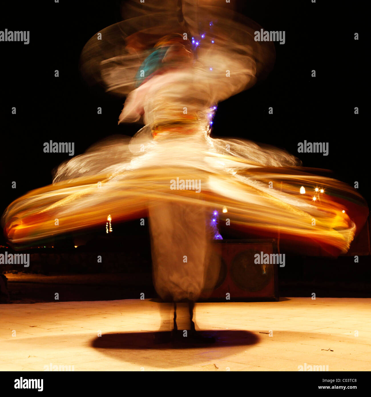 A Whirling Dervish dances to entertain tourists in Egypt. Whirling Dervishes are members of a Sufi order. Stock Photo