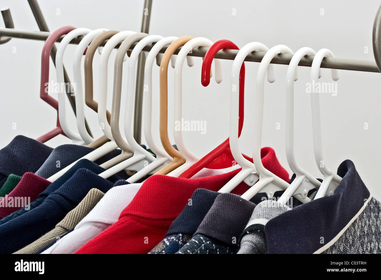 Shirts on hangers on a metal rack. Stock Photo