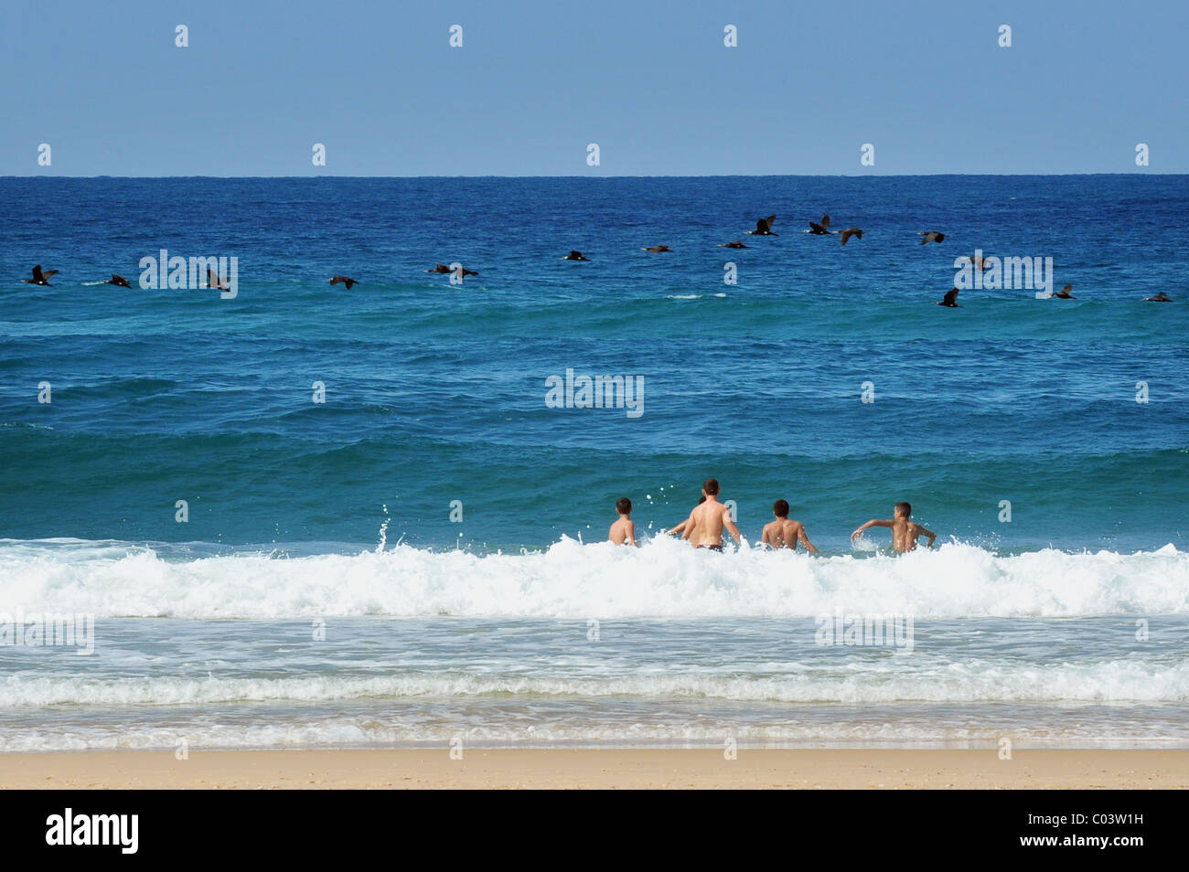 Four men swim in the Mediterranean sea of Israel Stock Photo