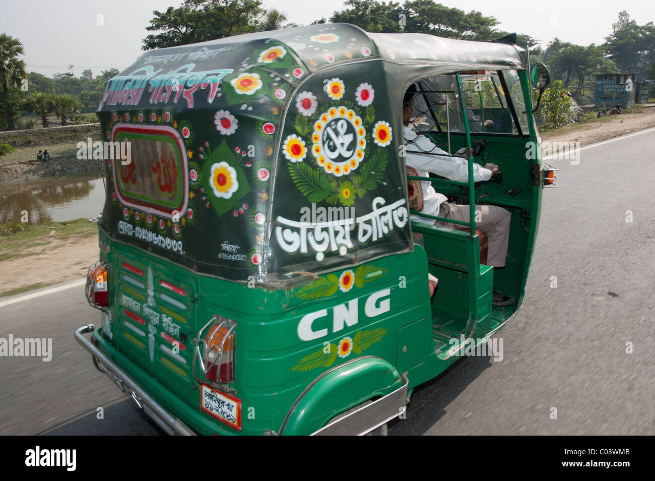 Bangladesh CNG natural gas powered tuk tuk driving along the Chittagong